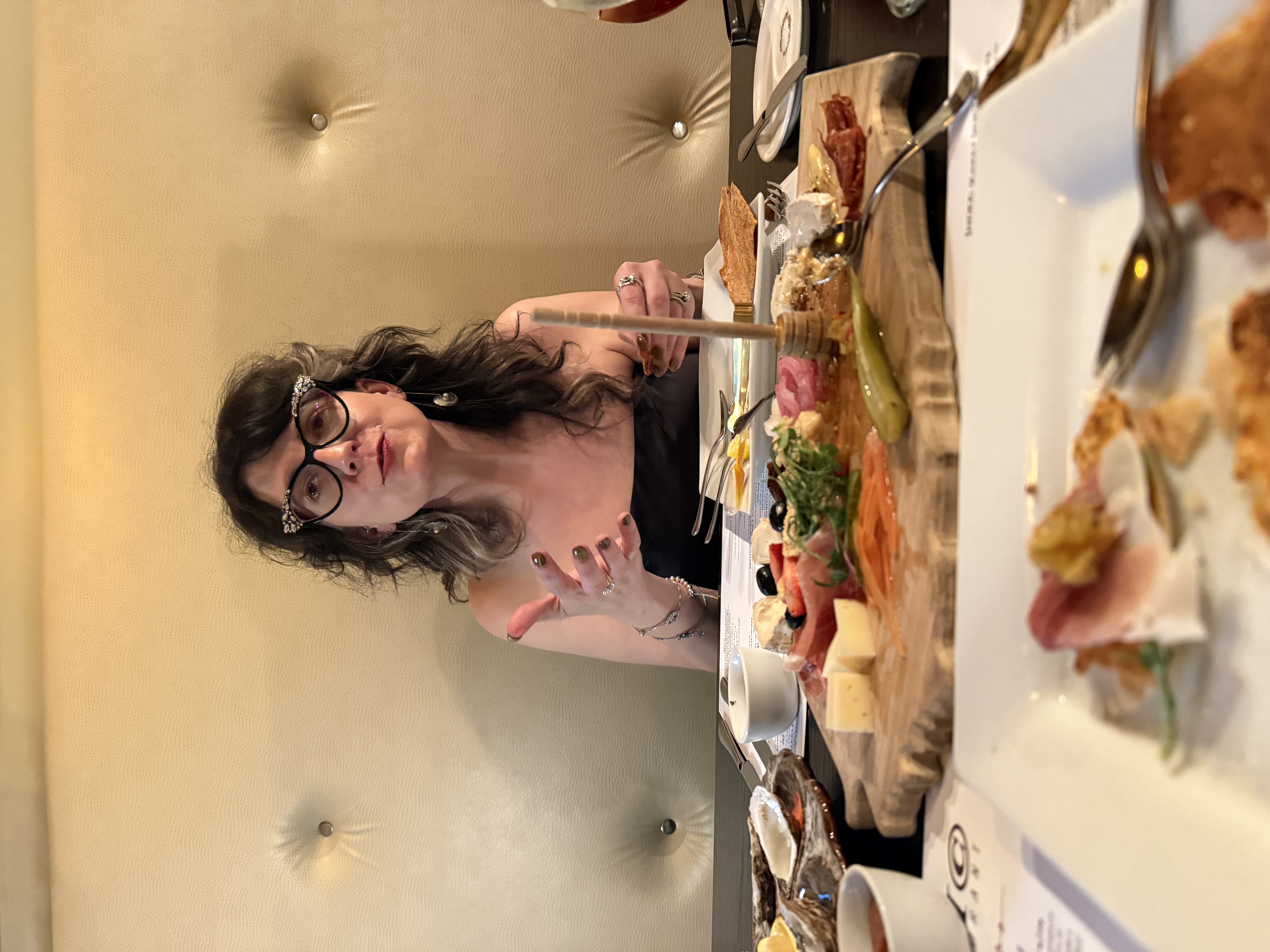 Sam mid-conversation over a charcuterie board