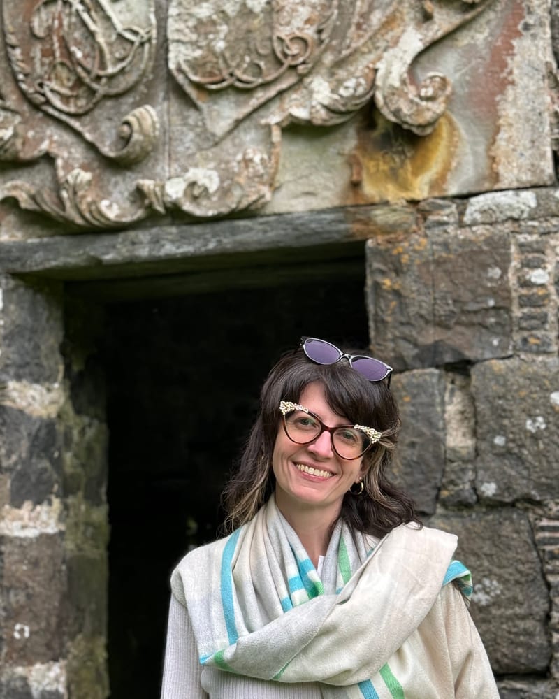Samantha K. Miller Gurski at a carved stone doorway in Scotland